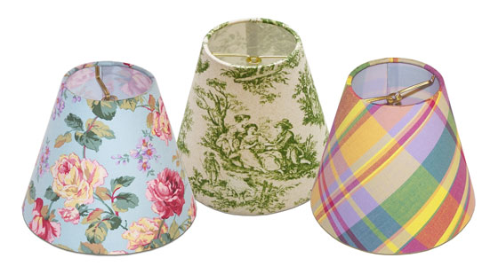 Small lampshades with flame clip fitters in various flower, toile and check printed fabrics for chandeliers or sconces.